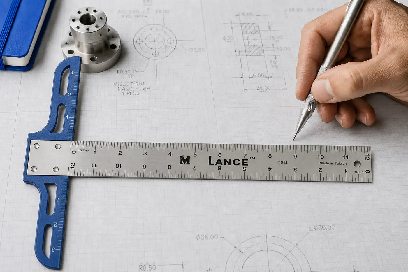 A pencil line meets the graduations of a Lance rule over a dimensional drawing